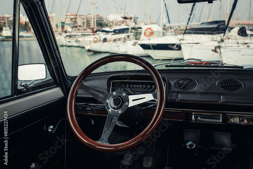 Old classic car interior with a steering wheel 