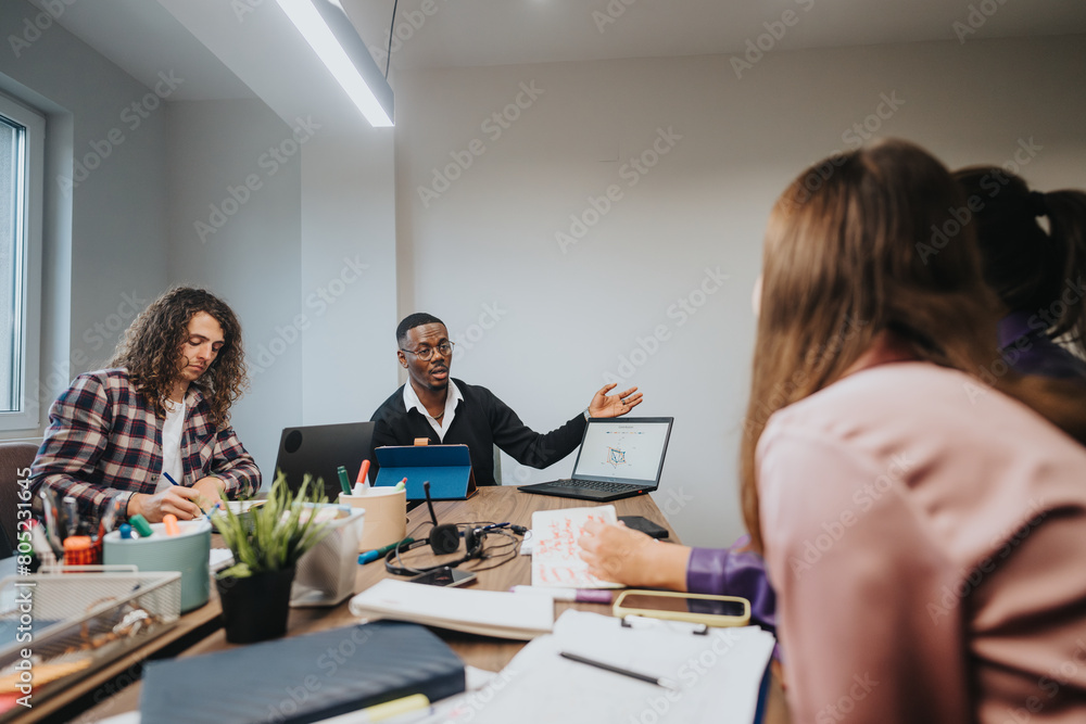 Diverse group of professionals collaborating in a brainstorming session, discussing project details in a well-lit, contemporary workspace. Diverse group of professionals collaborating in a brainstorming session, discussing project details in a well-lit, contemporary workspace.