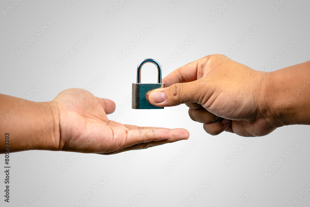 Two hands holding a key and a lock. Concept of trust and security