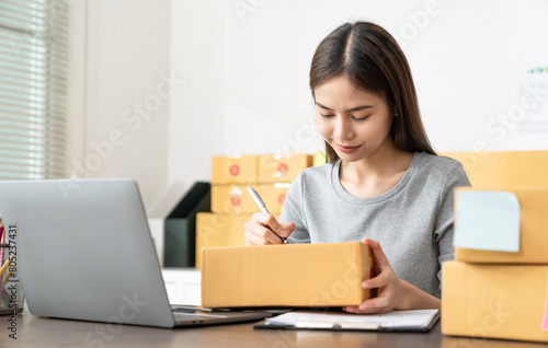 Startup small business, Young Asian women working freelance and packing box delivery products to customers, Ordered online.