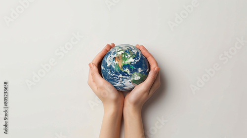 Female hands with model of Earth on white background -