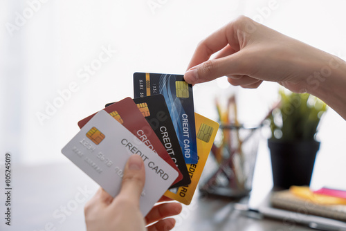 Woman holding credit card and select for shopping and pay online.