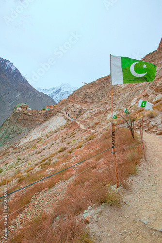 Trekking to Hopper Glacier in Pakistan. Pakistan national flag. 