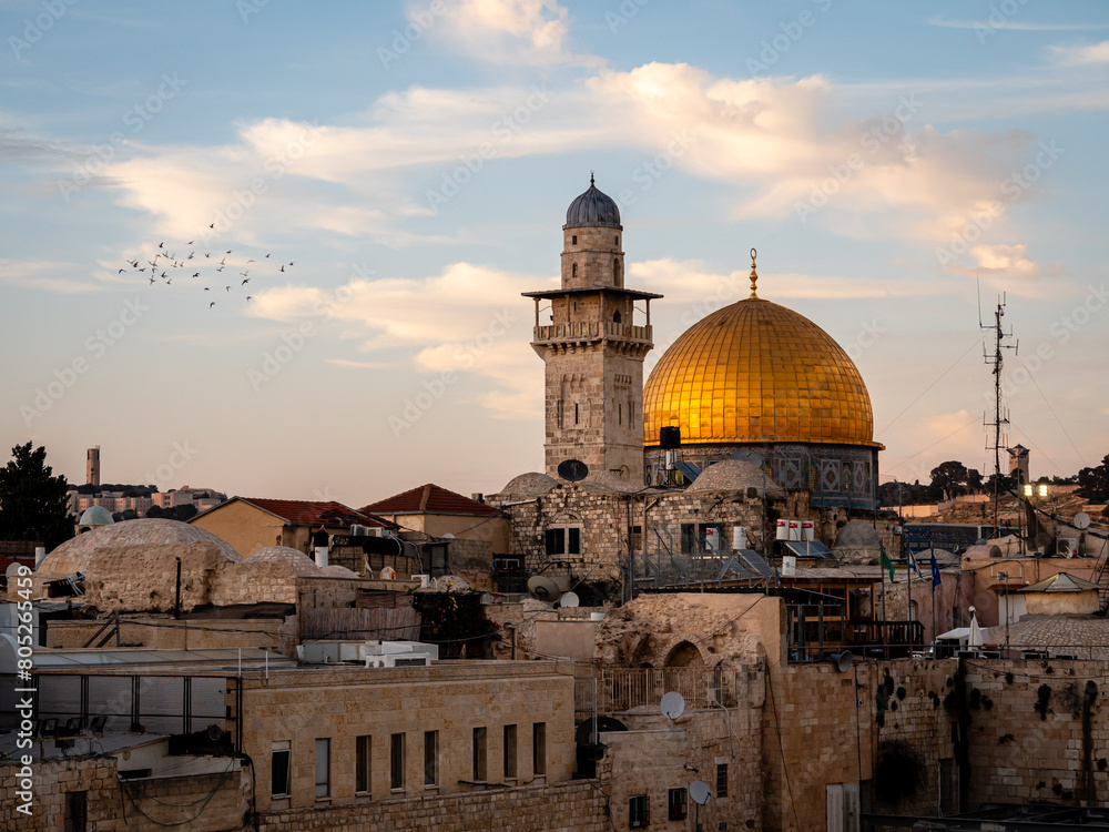 Fototapeta premium Birds flying around the dome of the Rock at sunset