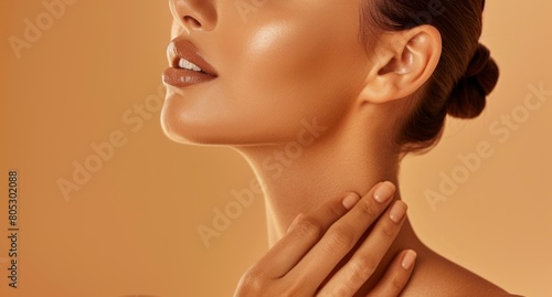 A Woman Touches Her Glowing Neck  Isolated Against a Brown Studio Background  Symbolizing Skincare and Beauty