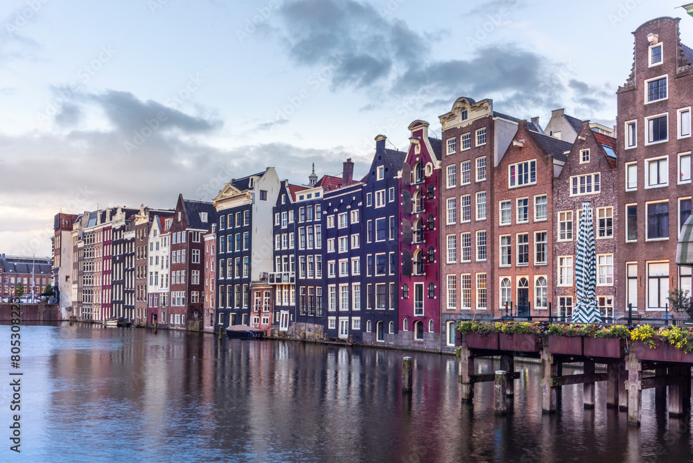 Fototapeta premium View of the Damrak canal dancing houses in Amsterdam at sunset