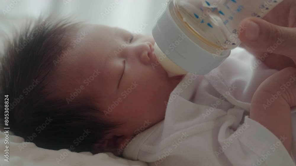 mother feeding her daughter child with milk baby bottle at home mother feeding her daughter child with milk baby bottle at home