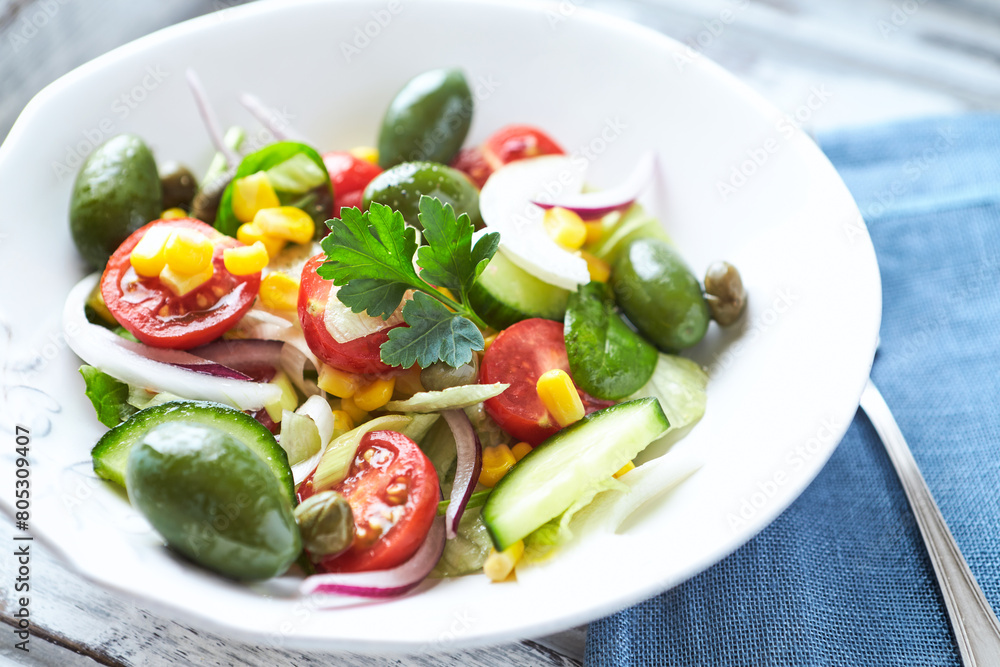 Simple Salad with Green Olives, Cucumber and Cherry Tomatoes. Bright wooden background. Simple Salad with Green Olives, Cucumber and Cherry Tomatoes. Bright wooden background.