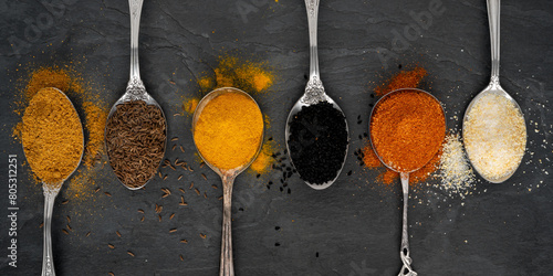 Various spices on tablespoons