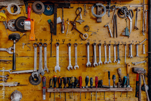 The tools of a workshop hanging on a wooden panel