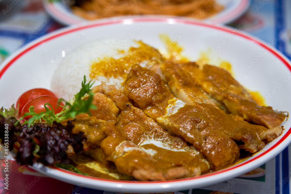 A delicious curry fried chicken chop rice in a Hong Kong tea restaurant A delicious curry fried chicken chop rice in a Hong Kong tea restaurant