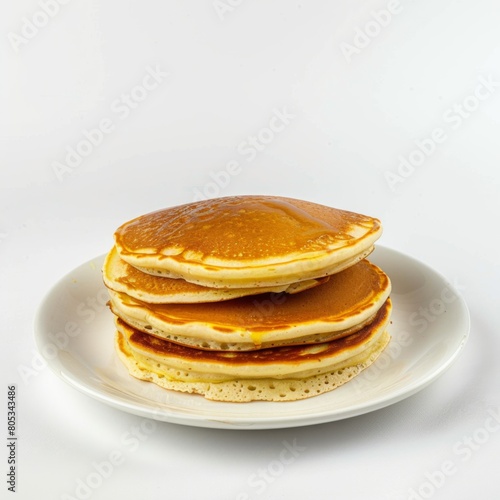 A stack of pancakes resting on a white plate