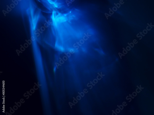 Blue light reflected in the dark for an energy minimalist abstract background. © Rapeeporn