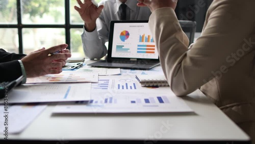 Financial advisor meeting is discussing analysis of business growth chart and market situation and financial planning.