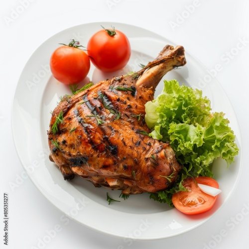 A white plate adorned with a succulent chicken and fresh vegetables