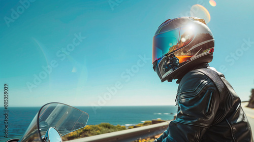 Motorcyclist on Coastal Road with Dramatic Ocean and Cliff Views 
