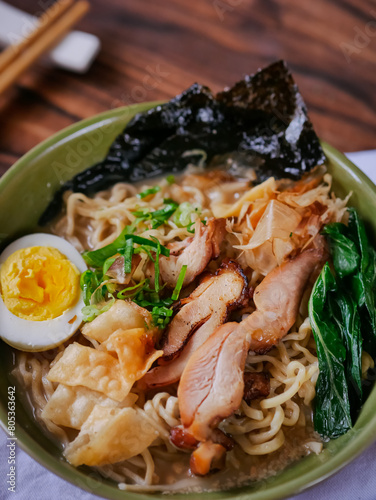 Toripaitan ramen in a bowl, with egg, vegetable, grilled chicken and nori
 photo