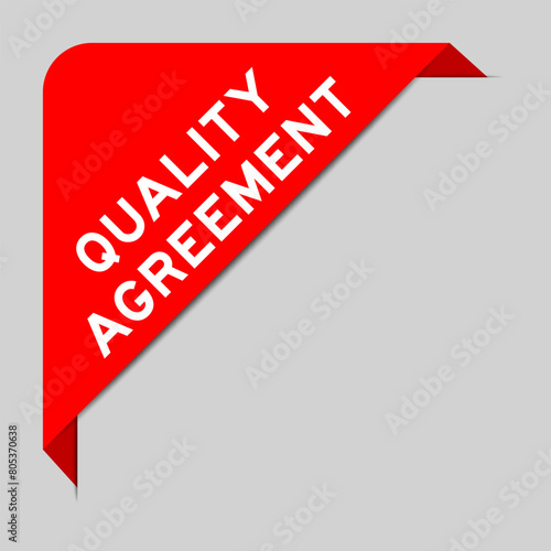 Red color of corner label banner with word quality agreement on gray background