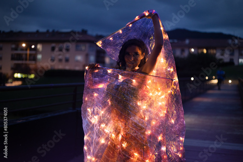 Belly dancer with wings of light under a starry sky	
