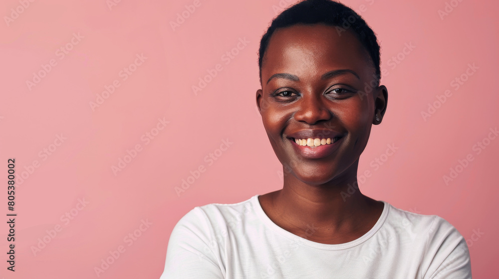 A woman with a big smile on her face is standing in front of a pink background A woman with a big smile on her face is standing in front of a pink background