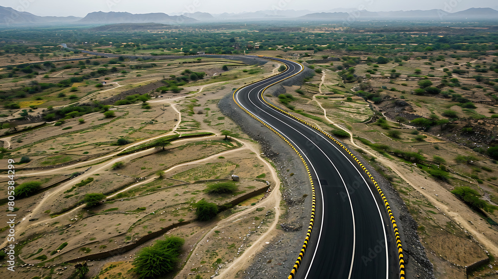 Black asphalt road with greenery mountains aerial view. Travel concept
