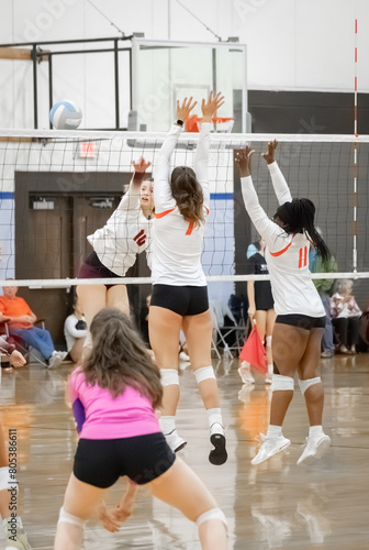 Female college volleyball player hitting cross