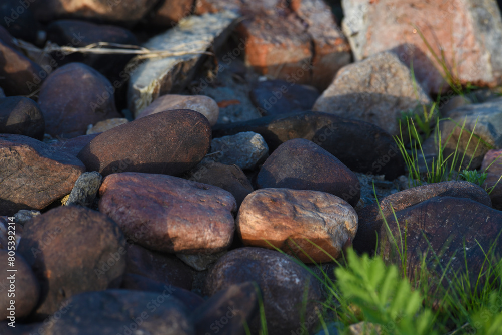 Colorful stones on the riverbank. Round stones on the beach. Colorful stones on the riverbank. Round stones on the beach.