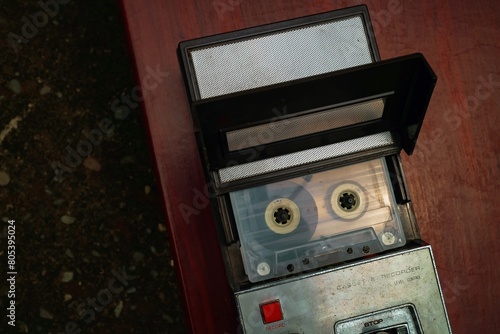 retro tape recorder playing a cassette tape on wooden table