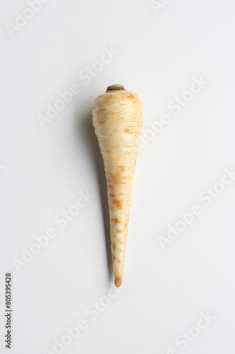 Top view of a fresh parsnip isolated on a white background. Parsnip (Pastinaca sativa) is a root vegetable closely related to carrot and parsley, all belonging to the flowering plant family Apiaceae.