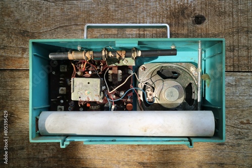 old transistor radio machine on wooden table, electric device interior