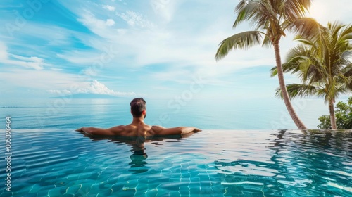 Luxury Resort. Man Relaxing In Infinity Swimming Pool Water. Beautiful Happy Healthy Male Model Enjoying Summer Travel Vacation At Tropical Spa Hotel In Indonesia  Sea View. Summertime Relax Concept