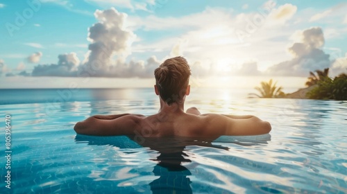 Luxury Resort. Man Relaxing In Infinity Swimming Pool Water. Beautiful Happy Healthy Male Model Enjoying Summer Travel Vacation At Tropical Spa Hotel In Indonesia, Sea View. Summertime Relax Concept © Nataliya