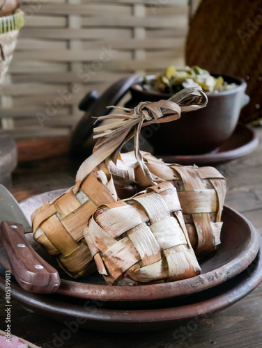 Ketupat, Special Dish Served at Eid al fitr or eid al adha or lebaran. Natural Rice Casing Made from Young Coconut Leaves, filled with rice and Boiled.Usually Served with opor ayam or sayur ketupat photo
