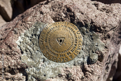 a peak bronze symbol of a geodetic survey at the lassen peak mountain, califronia  photo