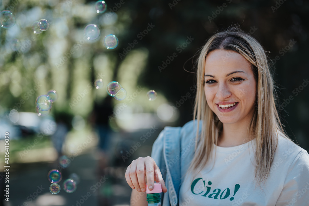 A joyful young woman with a bright smile spends her free time in a park, surrounded by floating soap bubbles, embodying happiness and leisure. A joyful young woman with a bright smile spends her free time in a park, surrounded by floating soap bubbles, embodying happiness and leisure.