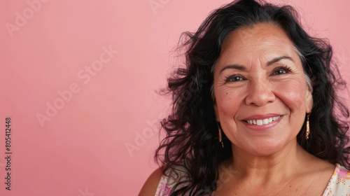 A woman with long hair and earrings is smiling