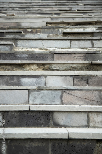 Vertical shot of an old destroyed concrete and stone steps of the stairs © alan