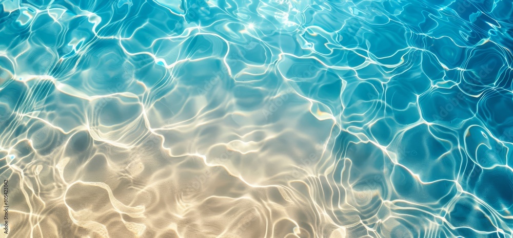 Summer background of clear sea water with sunlight in the water.