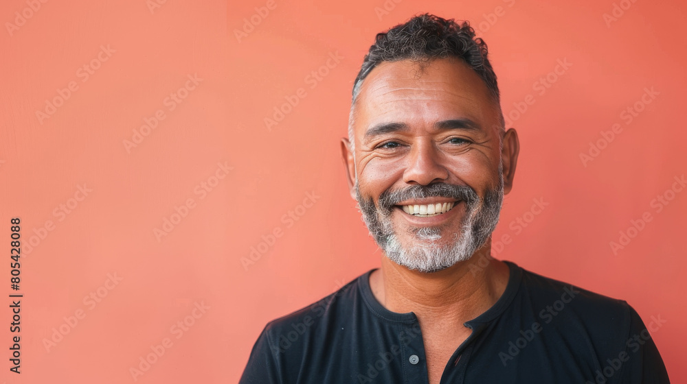 Fototapeta premium A man with a beard and gray hair is smiling at the camera