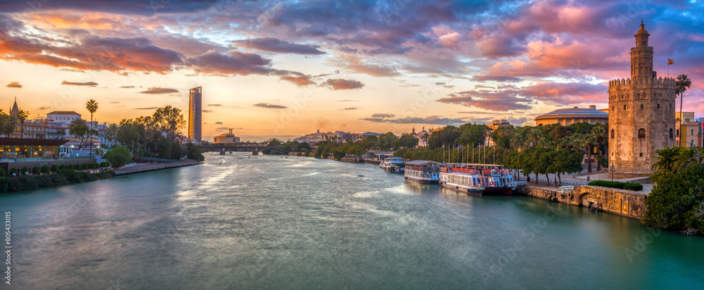 Fototapeta premium Panoramic view of the Guadalquivir River at dusk from San Telmo Bridge, Seville, Spain