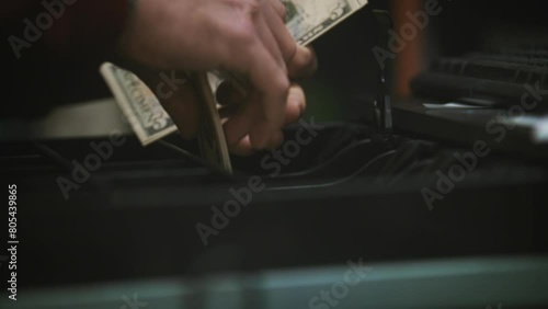 Person taking money from a cash register