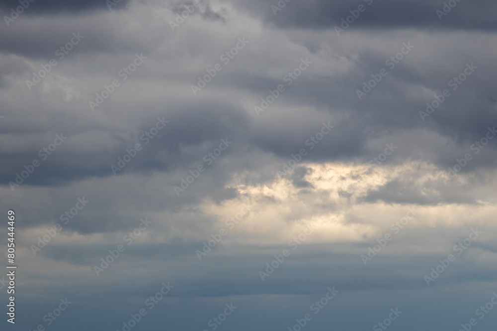 DarDark, gloomy, overcast, clouds gray and white with some yellowish light peeking through