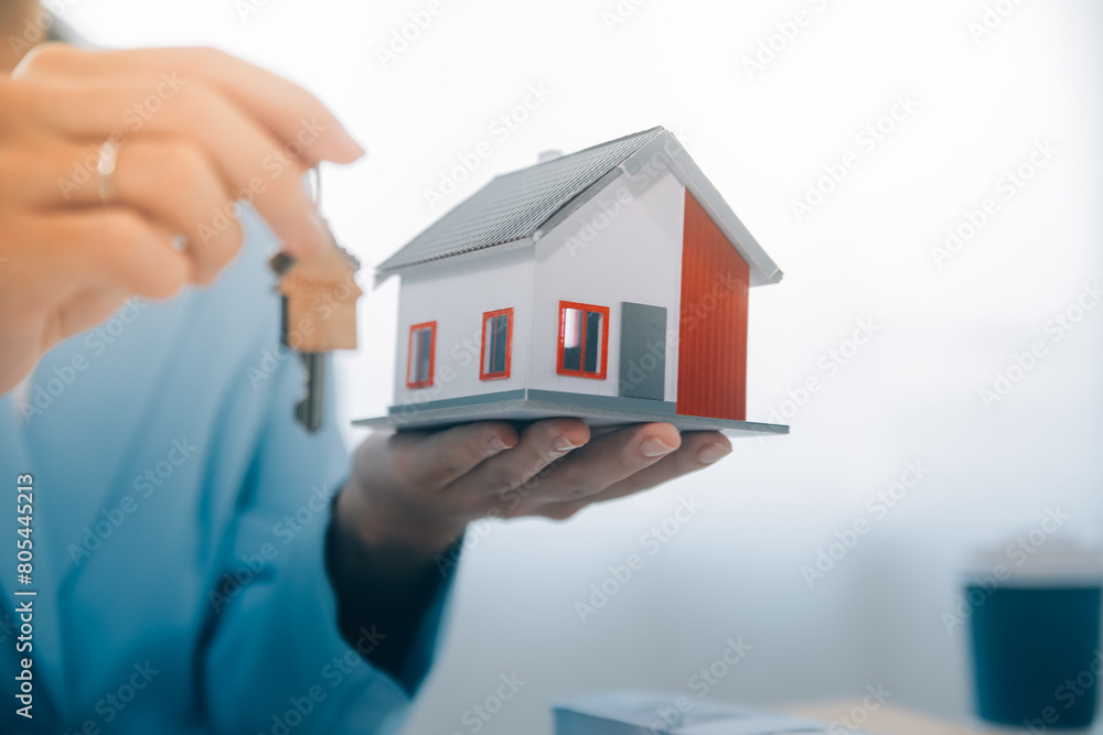Real estate agent talked about the terms of the home purchase agreement and asked the customer to sign the documents to make the contract legally, Home sales and home insurance concept. Real estate agent talked about the terms of the home purchase agreement and asked the customer to sign the documents to make the contract legally, Home sales and home insurance concept.