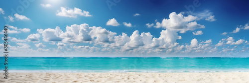 A beautiful beach and a clear blue sky. The sky is filled with clouds  giving the scene a serene and peaceful atmosphere