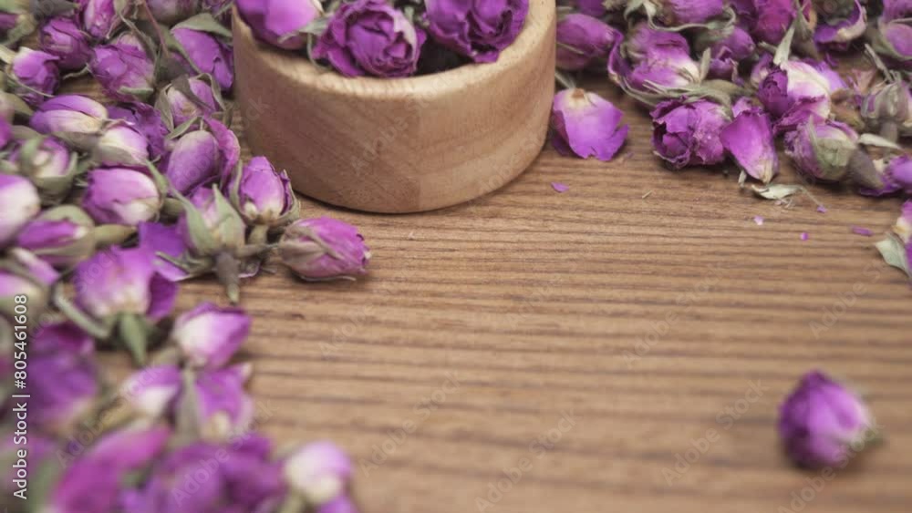 Dried damask rose buds in small bowl on wooden table Dried damask rose buds in small bowl on wooden table