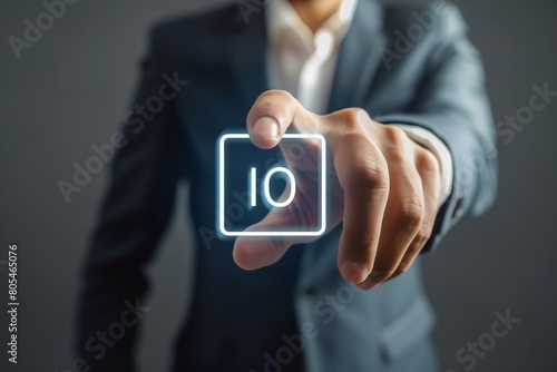 A man in a suit is pointing to a 10 on a screen
