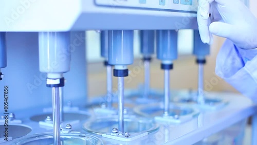 tablet dissolution test apparatus working condition close up. a scientific instrument dissolving tablets in a science instrumentation chemistry laboratory. tablet dissolving machine	