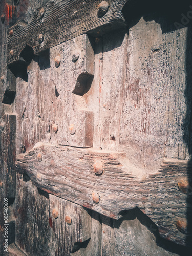 Ancient wooden door of a church, historic center of Verona, Italy