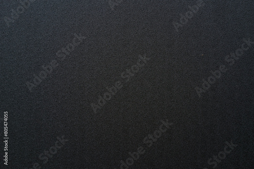 Photo of the texture of black ABS plastic. Black background with a high-resolution matte surface.