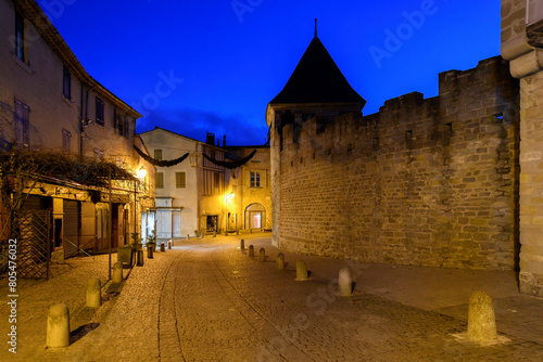 The medieval streets of shops and cafes illuminated at night in the walled medieval La Cite', at Carcassonne, France.